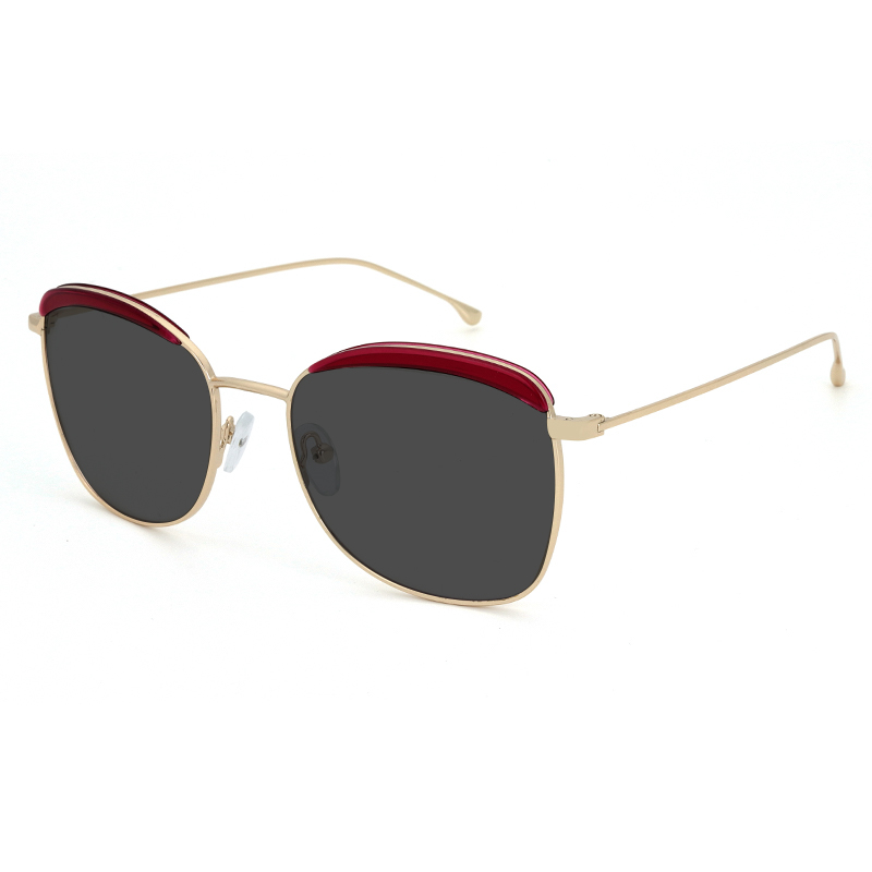 Gold toned metallic frame and temples with red acetate detail on the front and smoke color polarized lenses