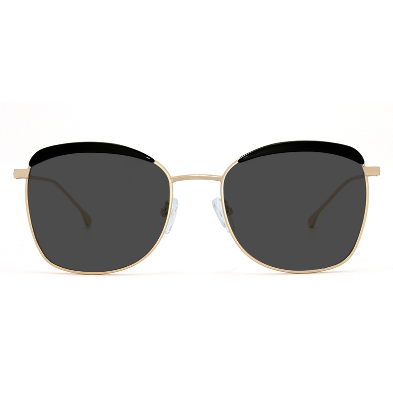 Gold toned metallic frame and temples with black acetate detail on the front and smoke color polarized lenses for 100% UV protection