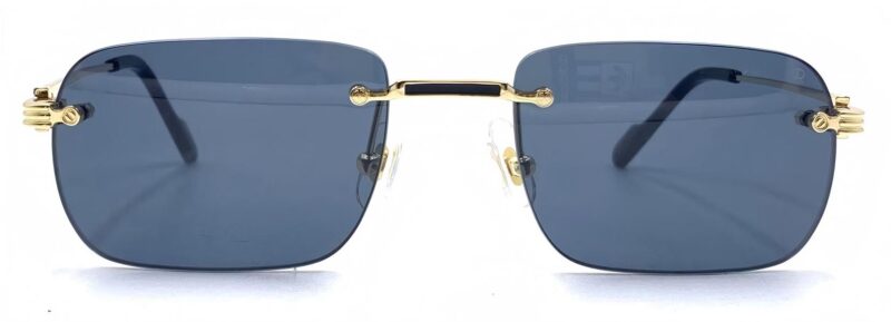 Man's, rimless frame with gold tone metallic temples and bridge and dark blue polar lenses.
