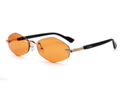 Unisex, rimless frame with gold tone metallic temples and bridge and orange transparent lenses. Black acetate temples tips