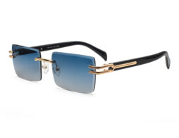 Unisex, rimless frame with gold tone metallic temples and bridge and blue gradient lenses. Black temples tips